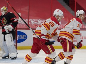 Feb 27, 2021; Ottawa, Ontario, CAN; Calgary Flames center Mikael Backlund (11) skates past Ottawa Senators goalie Matt Murray (30) after scoring a goal in the first period at the Canadian Tire Centre. Mandatory Credit: Marc DesRosiers-USA TODAY Sports ORG XMIT: IMAGN-445244