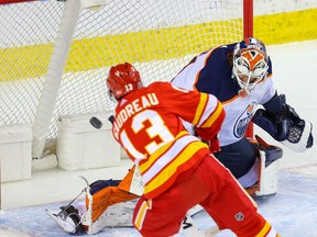 Edmonton Oilers goalie Mike Smith with a save on the Calgary Flames’ Johnny Gaudreau at the Saddledome on Friday, Feb. 19, 2021.