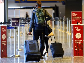 Passengers arrive at the Calgary International Airport from Cancun on Monday, Feb. 1, 2021. Flights to Mexico and the Caribbean have been cancelled until at least April 30.