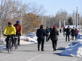 A busy Bow River pathway in Calgary's East Village on Saturday, Feb. 20, 2021.