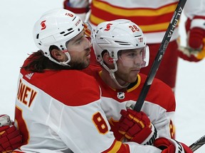 Calgary Flames forward Elias Lindholm (right) celebrates his first-period goal against the Winnipeg Jets during NHL action in Winnipeg with defenceman Chris Tanev on Thurs., Jan. 14, 2021. Kevin King/Winnipeg Sun/Postmedia Network