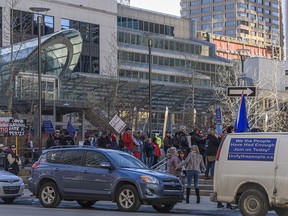 A group of around 70 people gathered at Courthouse Park in downtown Calgary to protest COVID-19 restrictions on Sunday, March 7, 2021.