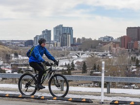 A cyclist moves along the pathway in Crescent Heights on Sunday, March 7, 2021.