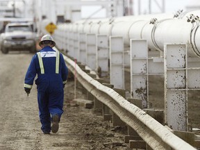 File photo: A worker walks along a new pipeline at the Enbridge facility in the east of Edmonton, May 16, 2008.