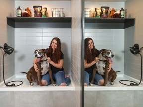 Alisha Lydon, 16, checks out the dog wash in the Cambridge Homes' show home in Riverstone, with her dog Beckham.