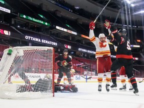 Flames forward Milan Lucic celebrates a second-period goal against the Ottawa Senators as Matt Murray , Braydon Coburn and Chris Tierney of the Ottawa Senators look on at Canadian Tire Centre on Monday night in Ottawa.