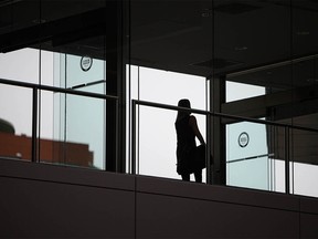 A person walks through a plus-15 walkway near the Chinese Cultural Center in Calgary on Wednesday, March 24, 2021.