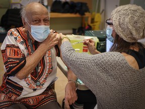 Abdul Makalai, 86, receives the COVID-19 vaccine from Corrina Bennett, RN at Silvera Aspen in Calgary. As of Saturday, Alberta reported 481,771 Albertans had received at least one dose of vaccine.