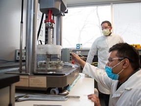 Dr. Brent Edwards, PhD, an associate professor in kinesiology, and postdoctoral scholar Ifaz Haider perform a fatigue test on a bone sample to better understand a rare fracture found in people with osteoporosis. SUPPLIED