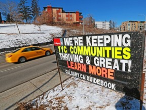 Multi-family buildings in Crescent Heights are seen behind a City of Calgary sign advertising the city's proposed new community guidebook on Tuesday, March 23, 2021.