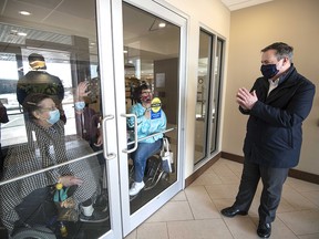 Premier Jason Kenney  chatted with residents through the glass front door at AgeCare Seton on Wednesday, March 3.