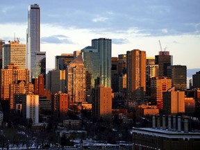 The rising sun illuminates the downtown Edmonton skyline on Thursday December 10, 2020.