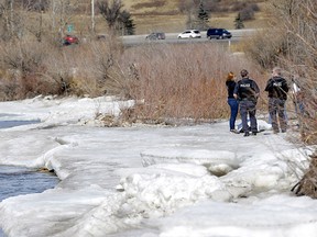Calgary police investigate after a body was found in the river near Harvie Passage in Calgary on Sunday, March 14, 2021.