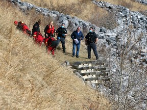 Emergency crews extract a body from the Bow River near Parkdale Blvd. and 32 St. NW. Sunday, March 21, 2021.