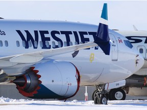 WestJet Boeing 737 MAX 8 registration number C-FHCM is parked in storage with older 737 aircraft on an unused runway at the Calgary International Airport on Thursday, February 25, 2021. C-FHCM was the aircraft WestJet used on the first commercial flight of company’s MAX 8 planes on January 21, 2021. 
Gavin Young/Postmedia