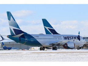 WestJet Boeing 737 MAX 8 registration number C-FHCM is parked in storage with older 737 aircraft on an unused runway at the Calgary International Airport on Thursday, February 25, 2021. C-FHCM was the aircraft WestJet used on the first commercial flight of company’s MAX 8 planes on January 21, 2021. 
Gavin Young/Postmedia