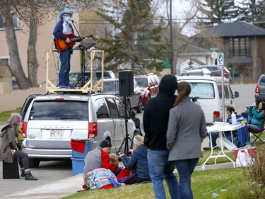 Matt Masters, founder of Curbside Concerts performs on top of his van during a Birthday Party in Calgary on Saturday, May 9, 2020. Darren Makowichuk/Postmedia