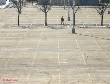 A nearly empty parking lot at Chinook Centre is shown on late Sunday morning on Sunday, March 22, 2020.Shopping malls are staying open but retailers will take a financial hit due to COVID-19. Jim Wells/Postmedia