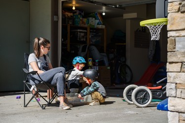 Danielle Loyns and and her 3-year-old son Archer and her 1-year-old daughter Austin spend the spring morning playing in their driveway in Sunnyside on Tuesday, April 28, 2020. With schools, daycares, playgrounds, social activities and gatherings cancelled during the COVID-19 pandemic, Loyns tries to entertain her kids in their driveway.
Azin Ghaffari/Postmedia