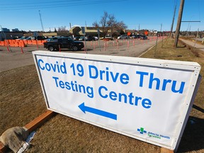 Cars drive into the COVID-19 testing centre on 32nd Avenue N.E. in Calgary on Tuesday, March 30, 2021.