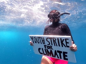 Mauritian scientist and climate change activist Shaama Sandooyea, 24, holds a placard reading Youth Strike For Climate, during an underwater protest at the Saya de Malha Bank to highlight the need to protect the world's largest seagrass meadow within the Mascarene plateau, Mauritius March 6, 2021.