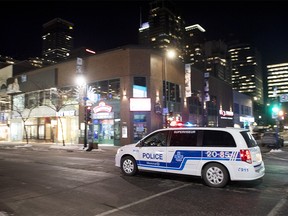 A police cruiser patrols Sainte-Catherine street in Montreal on Saturday, Jan. 9, 2021, as the COVID-19 pandemic continues in Canada and around the world. The Quebec government has imposed a curfew to help stop the spread of COVID-19.