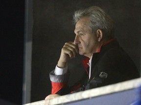 Darryl Sutter, at the time general manager, watches the Flames practice in 2020.