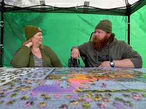 American citizen Regan Steele and her Canadian boyfriend Rod Greenwood work on a puzzle at Peace Arch Park, one of the few places where families can gather amid border restrictions between Canada and the U.S. due to the coronavirus disease (COVID-19) pandemic, in Surrey, British Columbia, Canada on March 13, 2021.