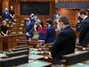 Prime Minister Justin Trudeau and other MPs take part in a moment of silence on the one year anniversary of the COVID-19 pandemic prior to question period in the House of Commons, Thursday, March 11, 2021.