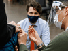 Prime Minister Justin Trudeau watches as a nurse gives a COVID-19 vaccination at a clinic in Ottawa, March 30, 2021.