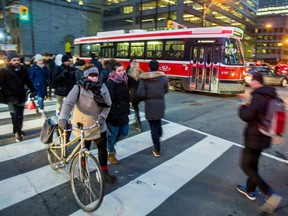 Pedestrians cross a street in downtown Toronto, in 2017.