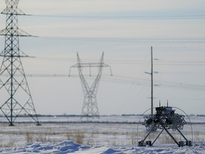 The LineFly robot, developed by Calgary companies AltaLink and FulcrumAir, installs bird markers on a transmission line near Leduc, Alberta.