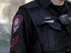 File photo: A Calgary police officer wears a "thin blue line" patch above his nametag.