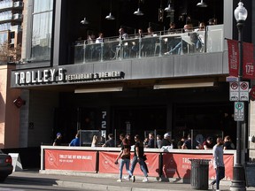 Guests are seen enjoying the outdoor patio at Trolley 5 Restaurant & Brewery during a warm afternoon on 17 Ave. S.W. Friday, March 12, 2021.