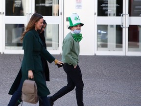 A man is seen wearing St. Patrick's themed clothing while walking along 9 Ave. S.W. Wednesday, March 17, 2021.