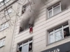One of four children is dropped from the window of a burning apartment.