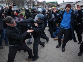 Police clear protesters from a square at the end of a demonstration demanding the compliance of basic rights and an end of the restrictive coronavirus measures in Kassel, central Germany, on March 20, 2021.