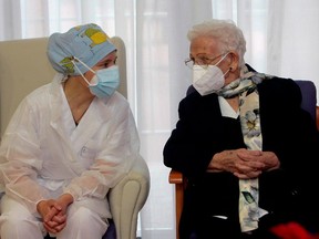 Monica (L), a nursing assistant and the youngest worker at the residence and Araceli Hidalgo, 96, a resident of Los Olmos nursing home for the elderly, are the first people to receive the first dose of the covid-19 vaccine in Spain on December 27, 2020 in Guadalajara, Spain.