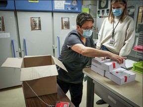 Alberta Health workers handle a shipment of AstraZeneca vaccine on March 9, 2021, in this photo on Health Minister Tyler Shandro's Twitter account.