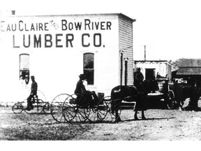 Historical photo of the Eau Claire and Bow River Lumber Co. building. The mill company ran log drives from 1887 to 1944. The photo also shows a couple of popular methods of transportation around yyc a century or so ago — a horse-drawn wagon and a now-antique bicycle.