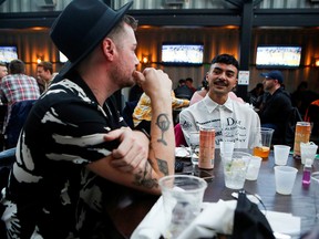 Knyckolas Davis, left, and Matthew Bettencourt celebrate Davis's 35th birthday with friends at Rizzo's Bar and Inn in Wrigleyville as COVID-19 restrictions are relaxed in Chicago on March 6, 2021.
