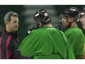 Then Calgary Flames head coach Darryl Sutter speaks with Craig Conroy and Jarome Iginla in this photo from December 2002.