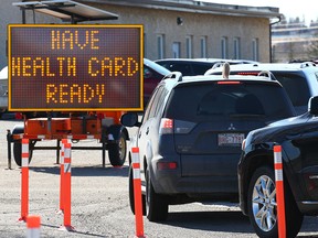 Cars line up at the COVID-19 testing centre on 32nd Avenue N.E. in Calgary on Tuesday, March 30, 2021.