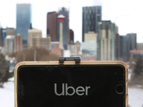 File photo: The Uber app is seen in a photo against a backdrop of Calgary's downtown skyline.
