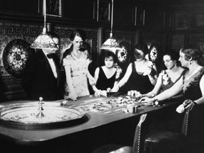 Patrons gather around a roulette table in Reno, Nevada on March 24, 1931.  Five days earlier, the Nevada governor signed a measure that legalized casino gambling. Archives photo.