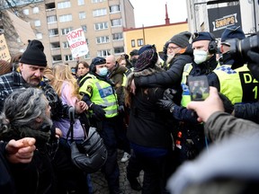 Swedish police break up a demonstration of coronavirus restrictions opponents protesting against a ban on large gatherings, in Stockholm, Sweden March 6, 2021.