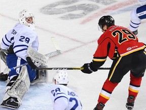 Stockton Heat centre Adam Ruzicka, right, scores on Toronto Marlies netminder Andrew D'Agostini at the Saddledome. (Courtesy of Stockton Heat)