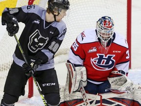 Calgary Hitmen forward Riley Stotts watches a ricocheting puck along with Lethbridge Hurricanes goalie Carl Tetachuk during WHL hockey action in Calgary, Sunday, March 1, 2020.