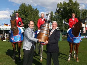 Team Germany, winners of the Nations' Cup, celebrate with Darryl White, BMO Financial Group CEO (front left) and German Chef D'Equipe Peter Hofmann during the Masters at Spruce Meadows in Calgary on Saturday, September 8, 2018. Jim Wells/Postmedia