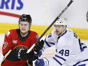 Stockton Heat forward Connor Zary battles for position with the Toronto Marlies' Calle Rosen, during AHL hockey action in Calgary in this photo from Feb. 21.